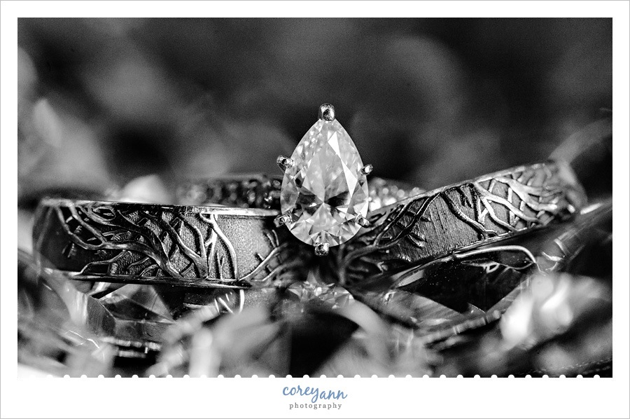 tear shaped diamond ring o top of tree wedding bands