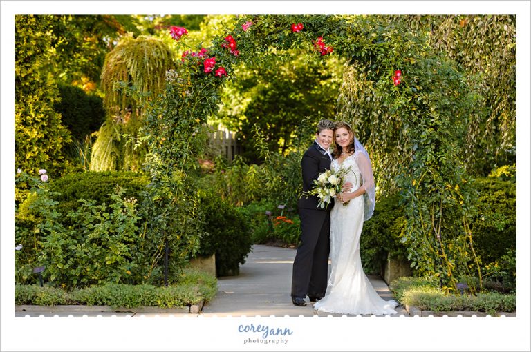 classic wedding portrait beneath arbor at cleveland botanical gardens