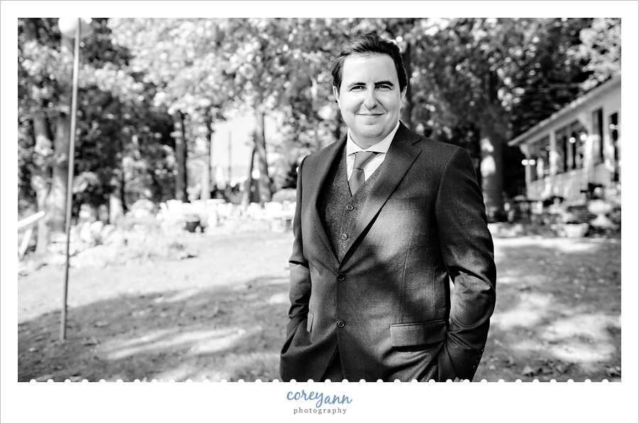 Groom in suit before first look