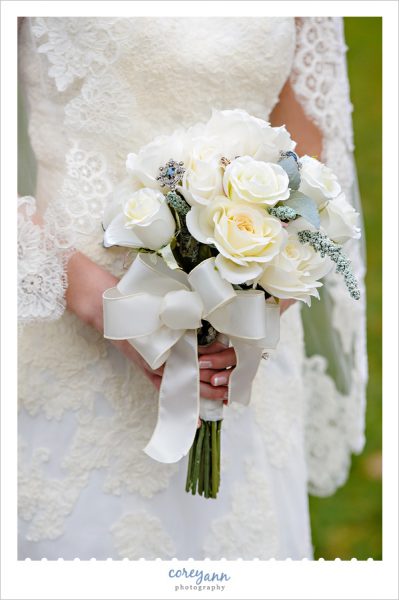 Bride with white and blue floral bouquet