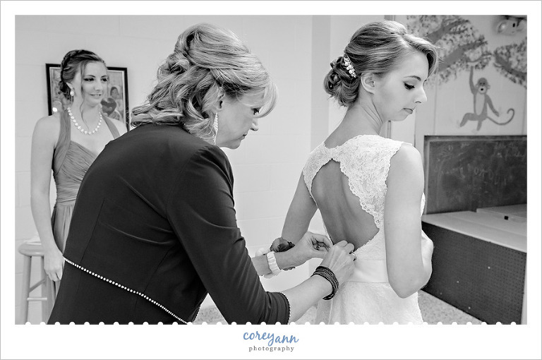 bride mother getting bride ready at st michael in canfield