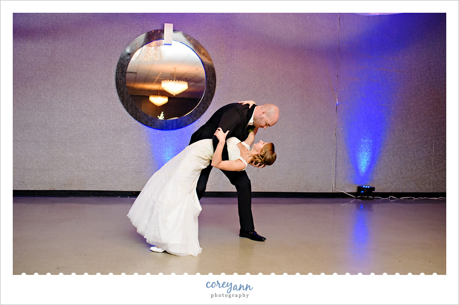 Groom dipping bride after first dance during wedding reception