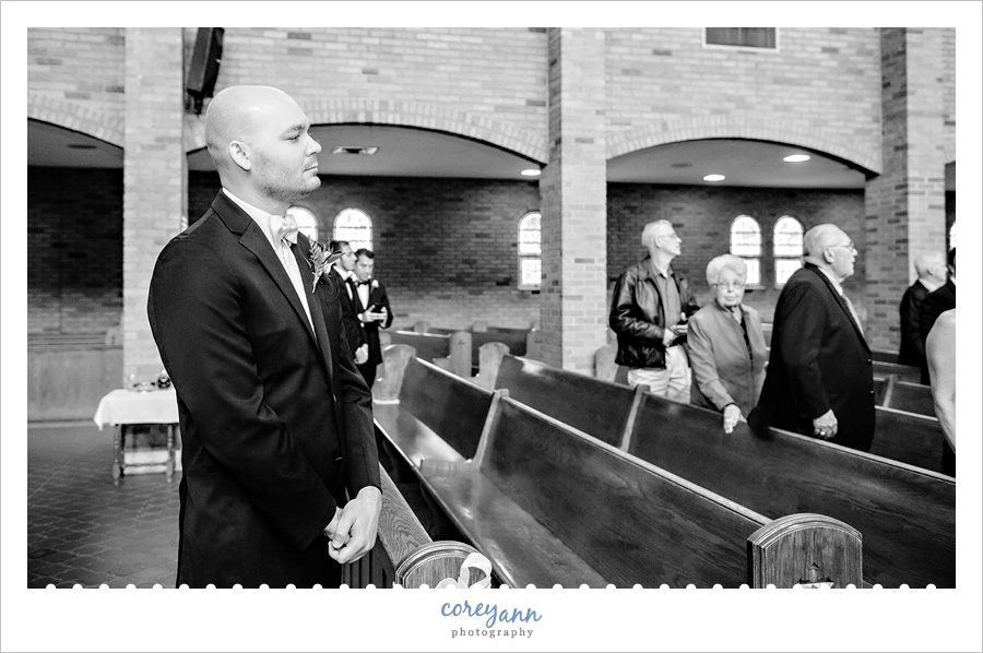 Groom watching Bride walk down aisle 