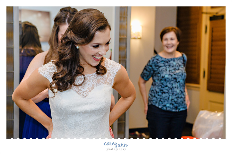 Bride putting on Augusta Jones Bridal Gown in Cleveland