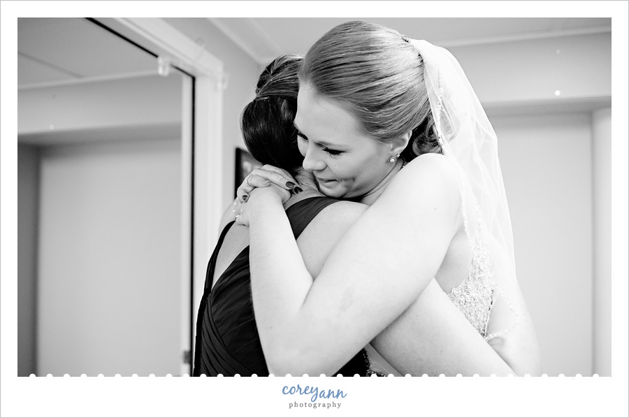 Bride hugging Mom after getting dressed