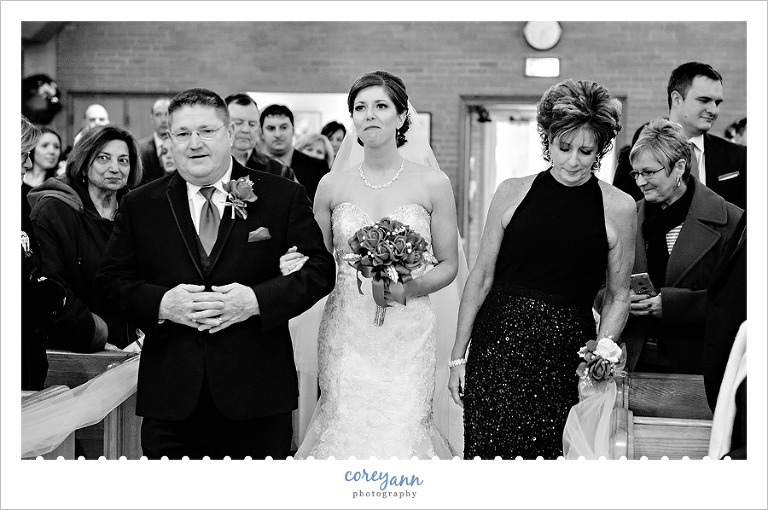 Bride and parents walking down aisle