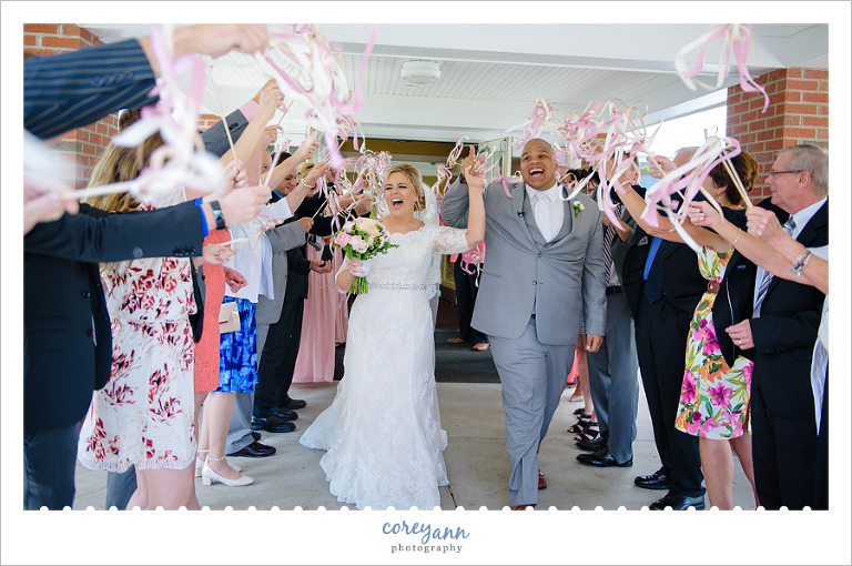 Bride and groom exiting with ribbon wands