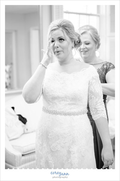 Bride getting emotional after putting on dress