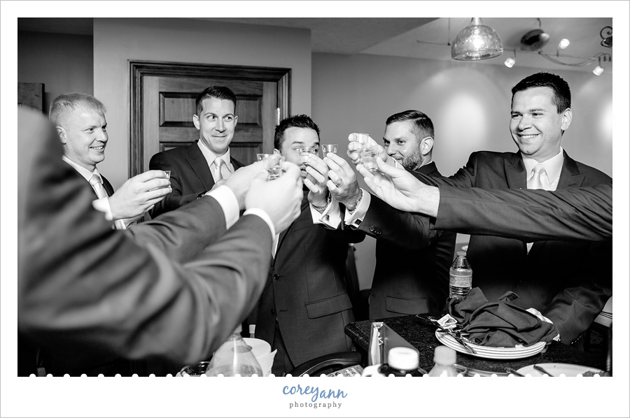 Groomsman toasting before wedding in Akron