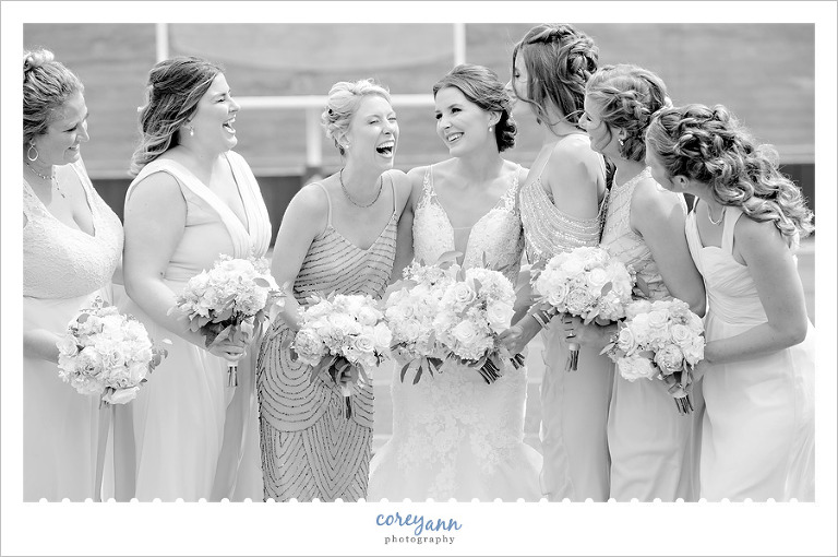 Bridesmaids laughing with Bride on Football Field
