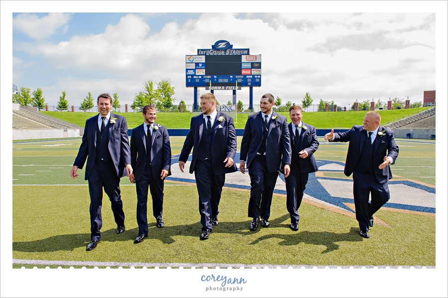 Groom and Groomsman on a Football Field