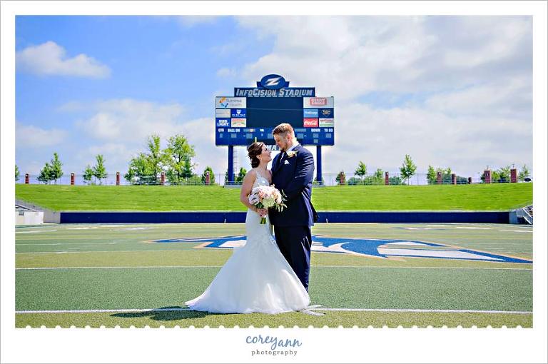 Summer wedding portrait at Infocsion Stadium at the University of Akron.