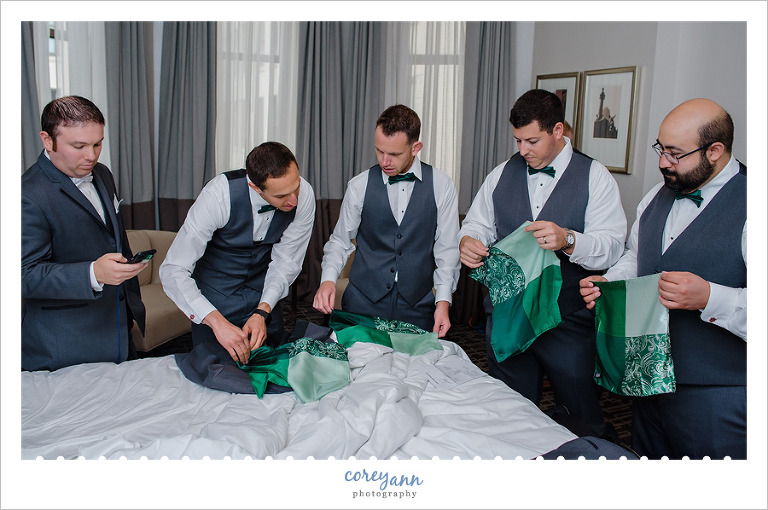 Groom and groomsman trying to figure out pocket squares