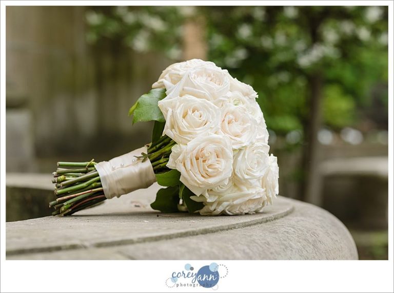 Cream rose hand tied bouquet by the budding tree in Cleveland