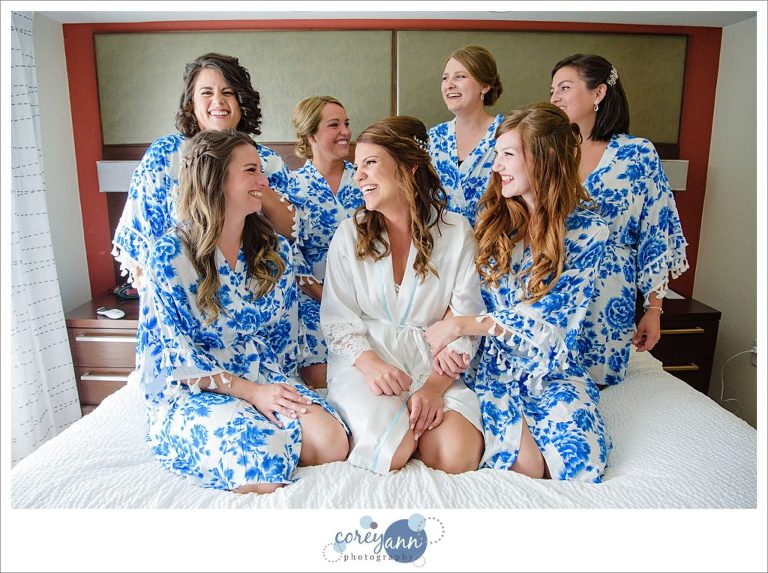 bride and bridesmaids on bed