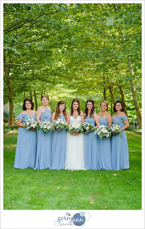Bride with bridesmaids in light blue gows
