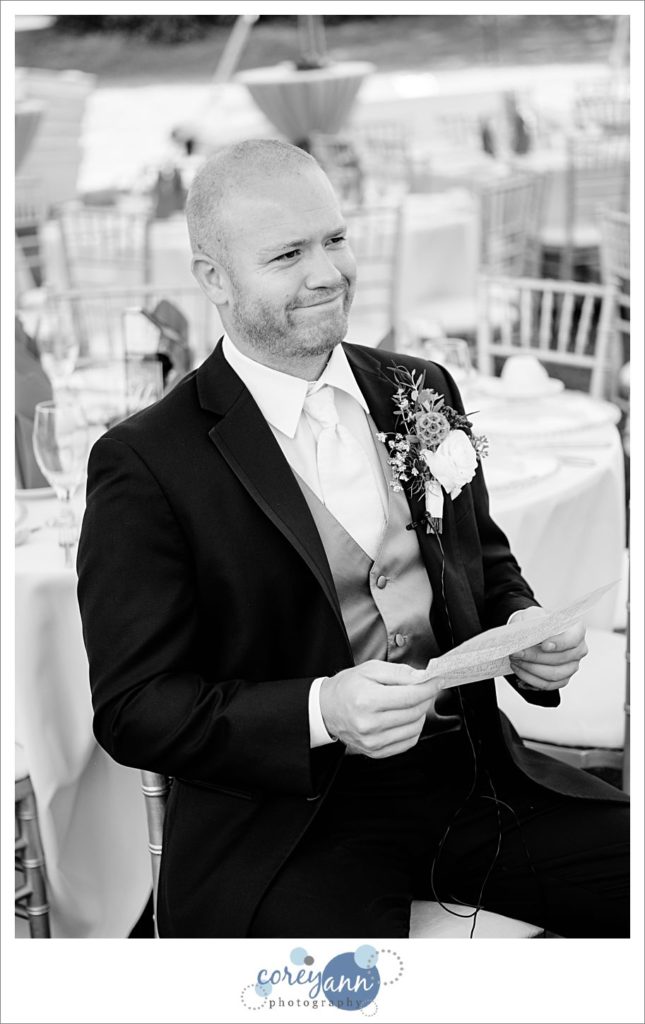 Groom reading letter from bride before wedding in ohio