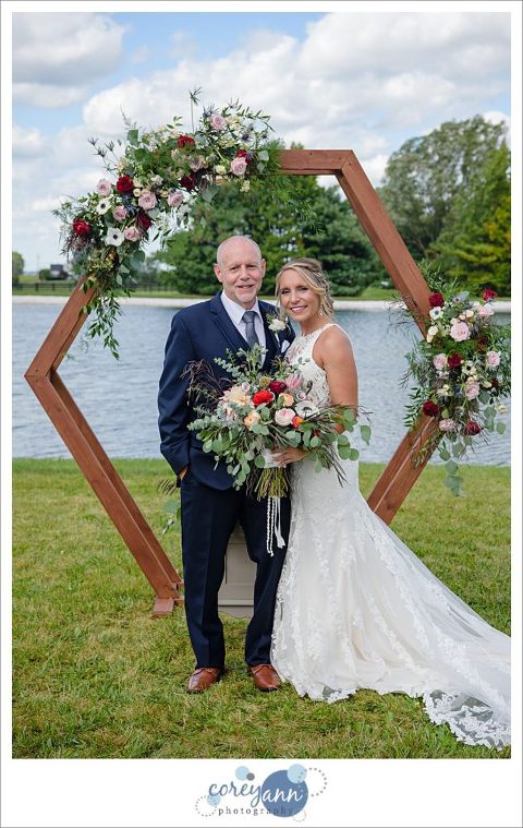 Bride and Dad with octagon arch he made