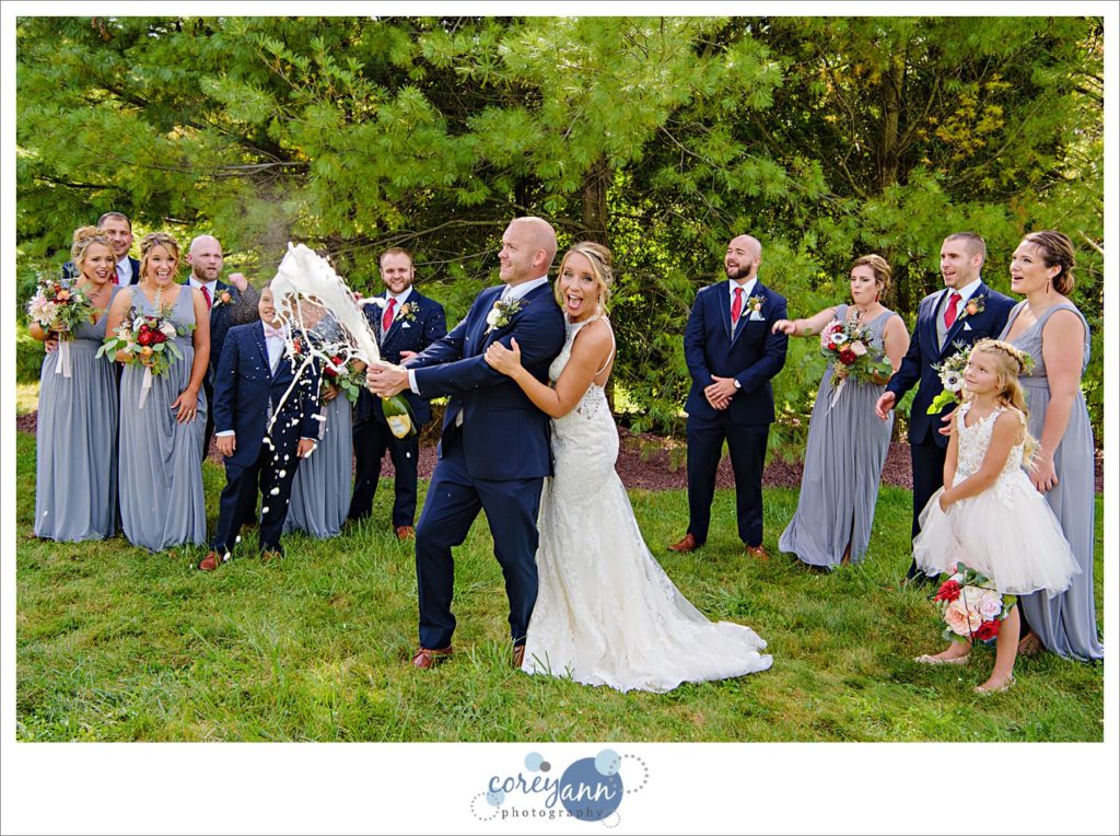 Bridal party opening champagne before wedding in Ohio