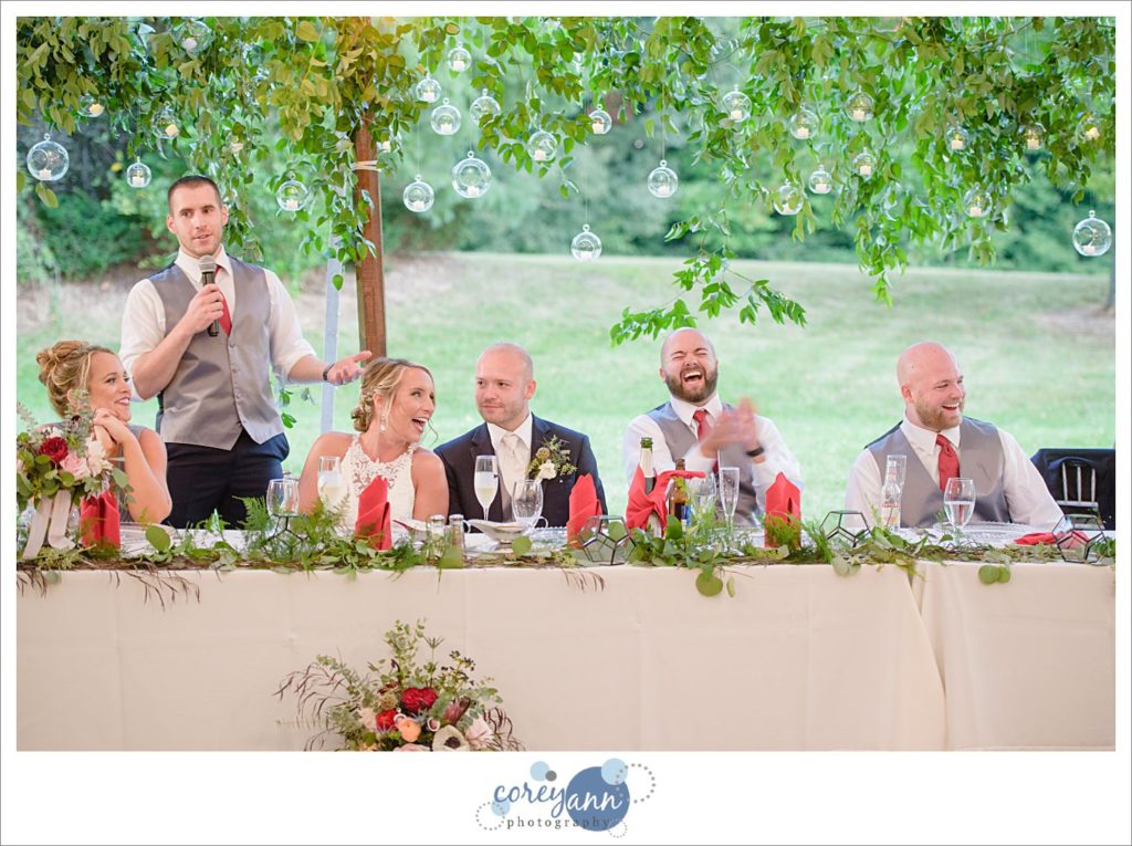 Toasts at outdoor wedding reception on a farm in Ohio