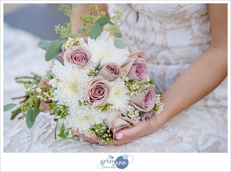 Bride holding bouquet with roses 