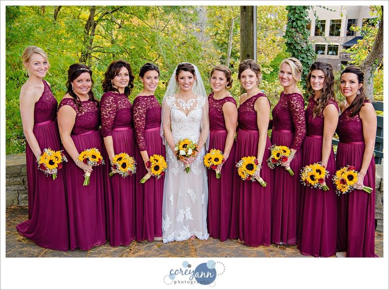 Bride with bridesmaids in burgundy dresses and sunflowers 