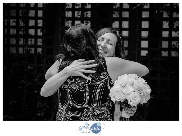 Bride and friend hugging after ceremony at Walt Disney Swan