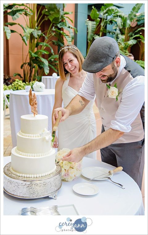 Bride and Groom cutting wedding cake at Walt Disney World Swan 