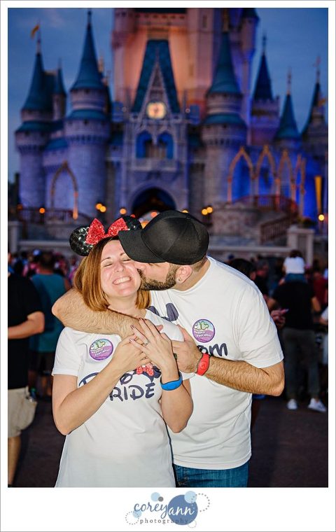 Groom kissing Bride in front of Cinderella Castle at Magic Kingdom