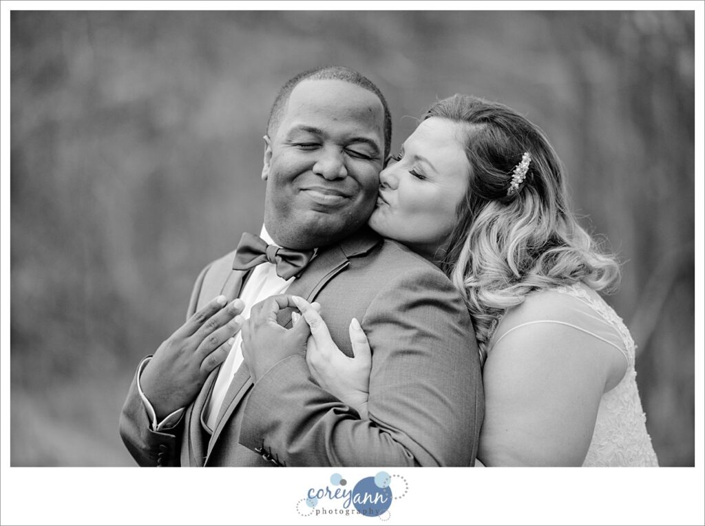 Bride kissing groom on cheek at Mapleside Farms wedding