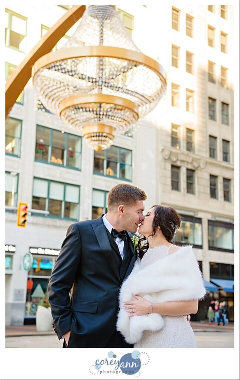 Bride and groom kissing after wedding at Playhouse Square chandelier