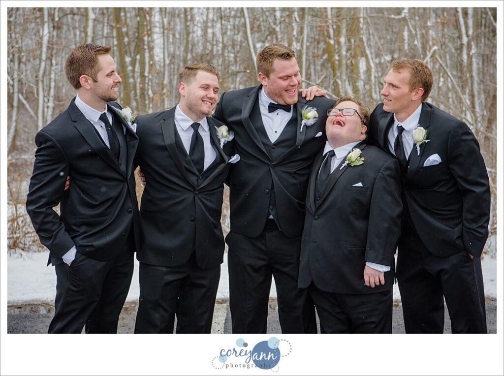 wedding groomsman in snow at boettler park in green ohio