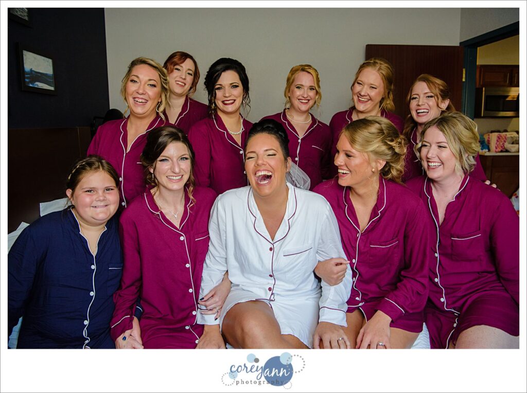 bride and bridesmaids on bed before wedding
