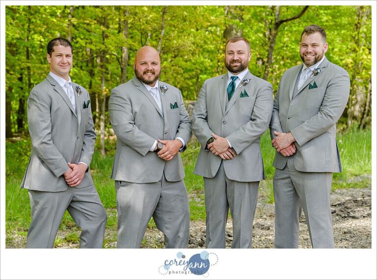 Groom and groomsman in grey suits with green ties