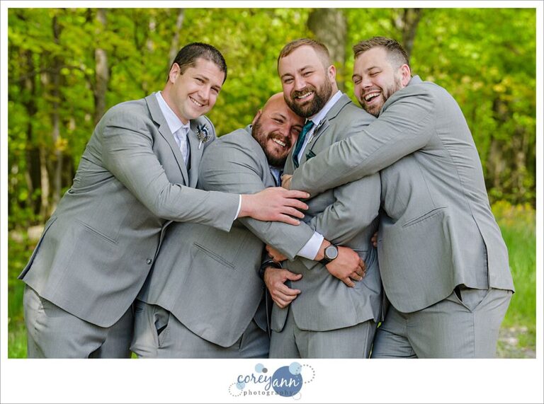 Groom and groomsman in grey suits with green ties