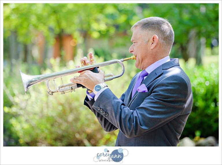 Groom playing trombone for wedding ceremony in Ohio