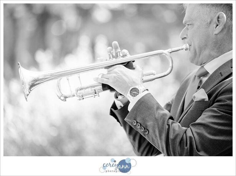 Groom playing trombone for wedding ceremony in Ohio