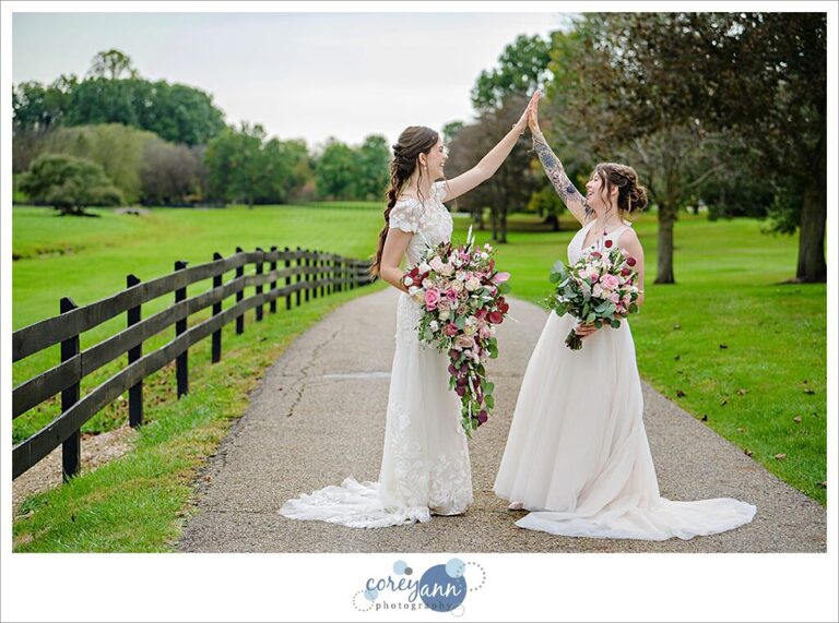 Brides high fiving after ceremony at Brookside Farm