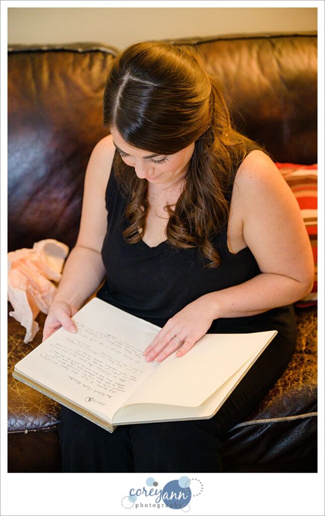 woman reading wedding gift from her husband on a couch