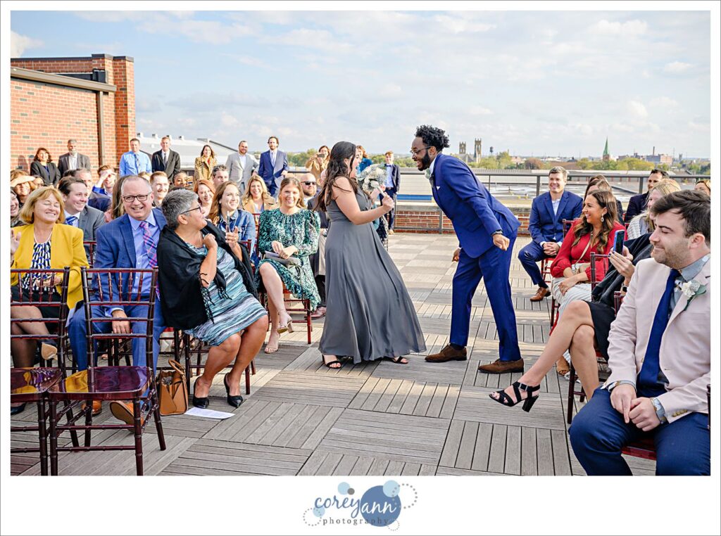 Bridesmaid and Best Man dancing up the aisle before wedding ceremony at Ariel International Center 