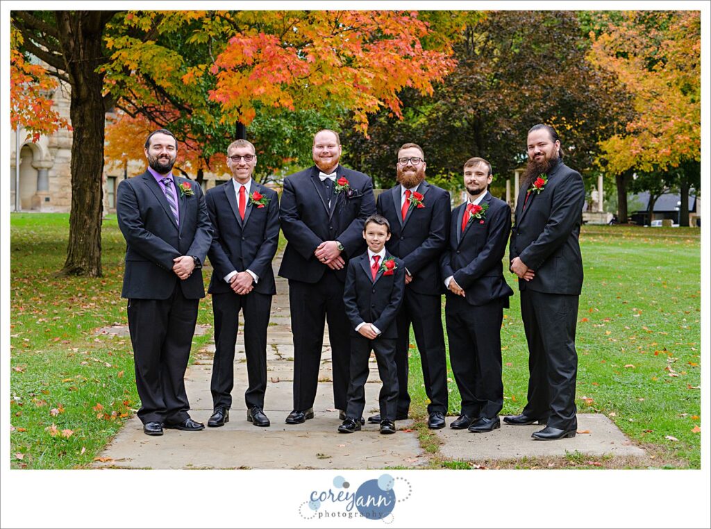 Groom and groomsman wearing black suits with red ties in Warren, Ohio