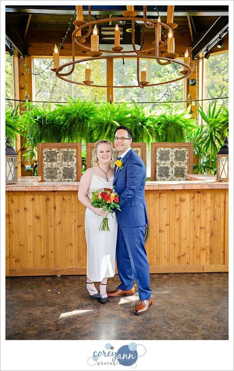 Bride and Groom posing inside conservatory after wedding at Gervasi Vineyard.