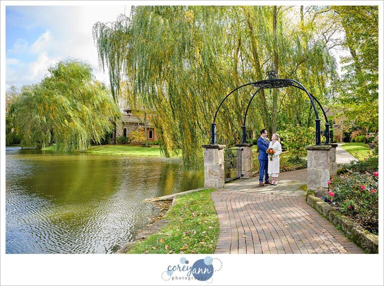 Bride and Groom posing on the iron bridge near the pond at Gervasi Vineyard after their wedding.