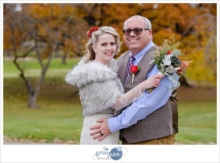 Bride and Groom posing outside in November during their wedding at Prestwick Country Club