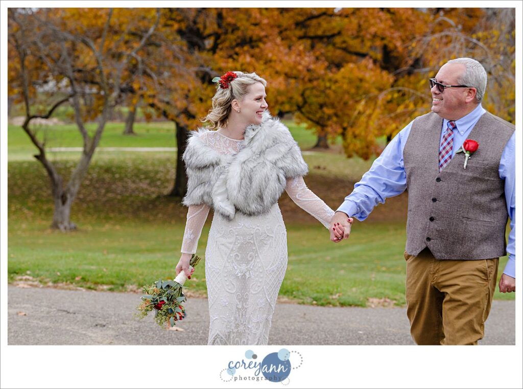 Bride and Groom holding hands and walking outside on their wedding day at Prestwick Country Club