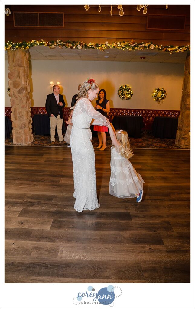 Bride dancing with flower girl at wedding reception in Ohio