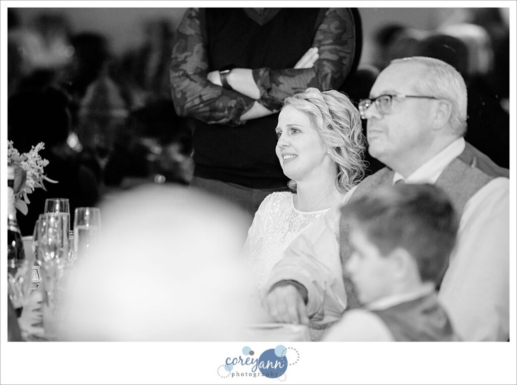 Bride and groom listening to friend give them a wedding toast in Green Ohio