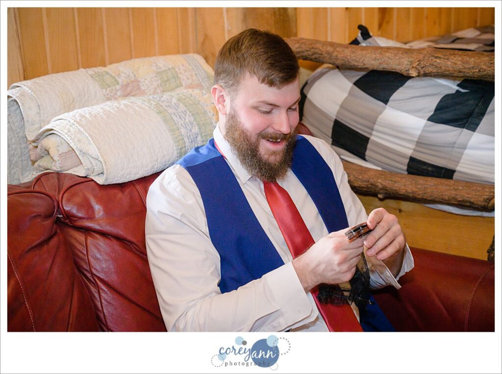 Groom opening gift for wedding at Rivercrest Farm