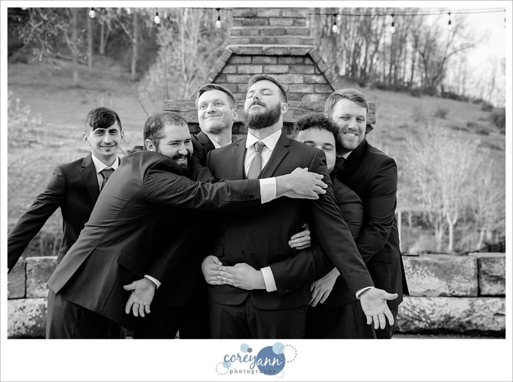 Groomsman hugging groom before wedding in Dover Ohio