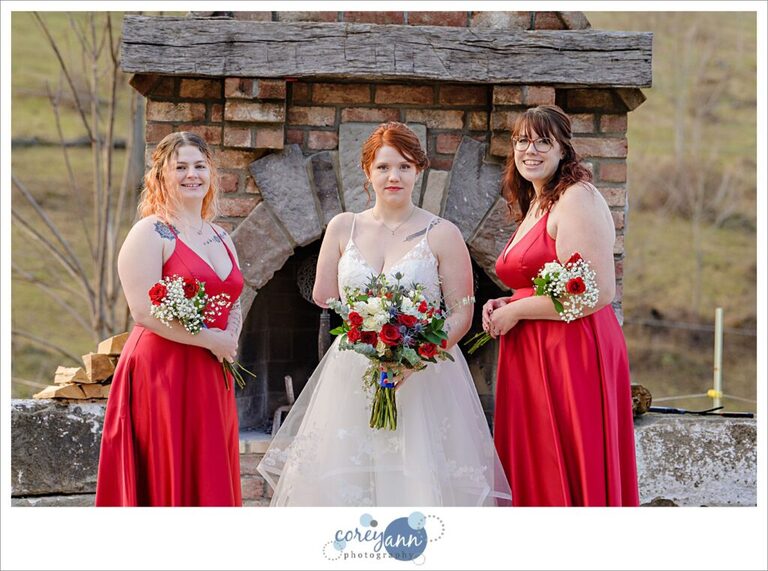 Bride with two bridesmaids in red dresses from David's Bridal